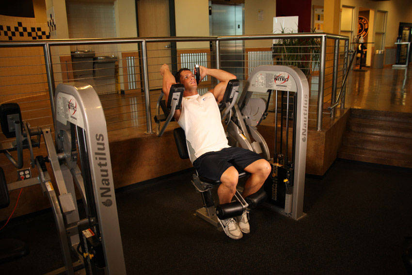 Demonstration of Ab Crunch Machine exercise showing proper form and technique