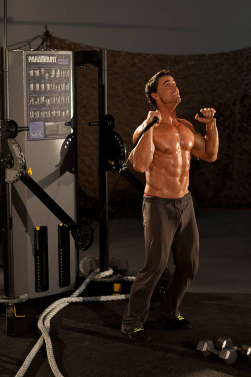 Demonstration of Alternating Cable Shoulder Press exercise showing proper form and technique