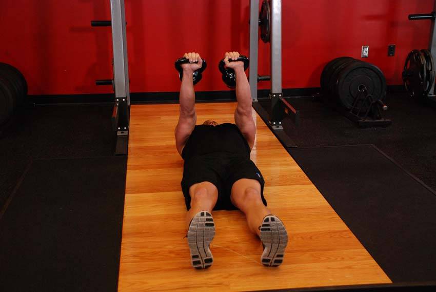 Demonstration of Alternating Floor Press exercise showing proper form and technique