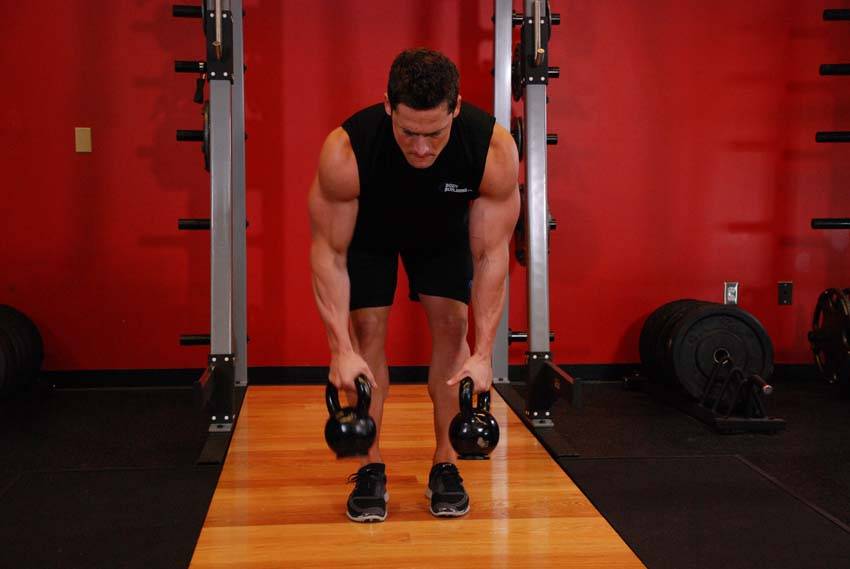 Demonstration of Alternating Kettlebell Row exercise showing proper form and technique