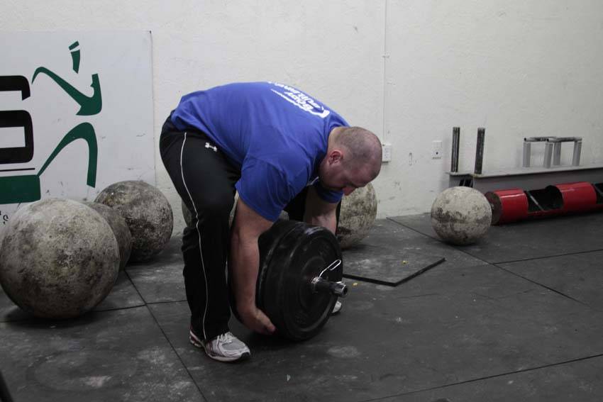 Demonstration of Atlas Stone Trainer exercise showing proper form and technique