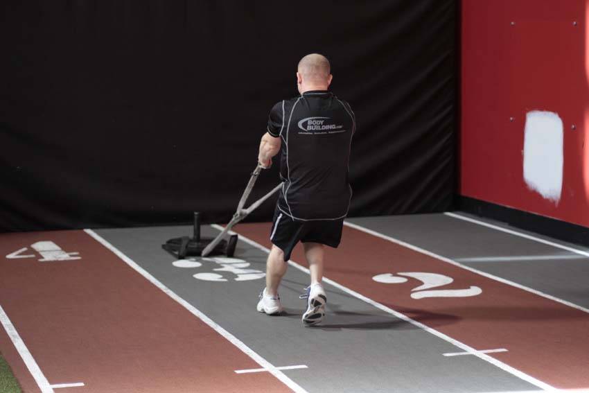 Demonstration of Backward Drag exercise showing proper form and technique