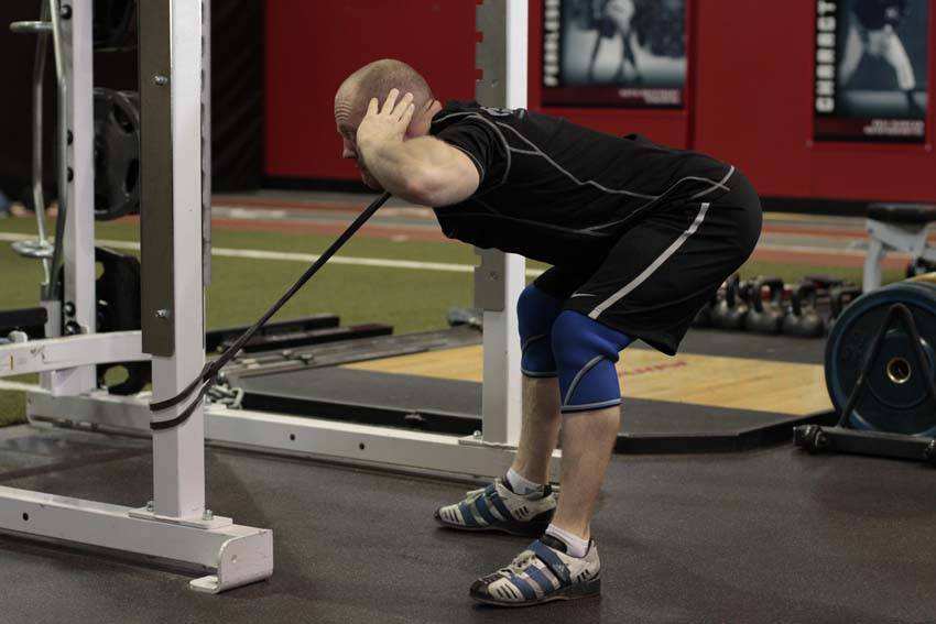 Demonstration of Band Good Morning (Pull Through) exercise showing proper form and technique