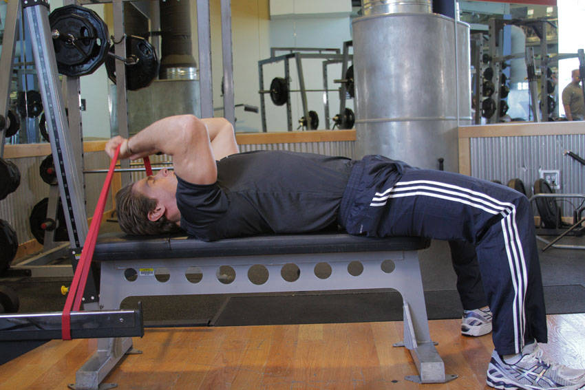 Demonstration of Band Skull Crusher exercise showing proper form and technique