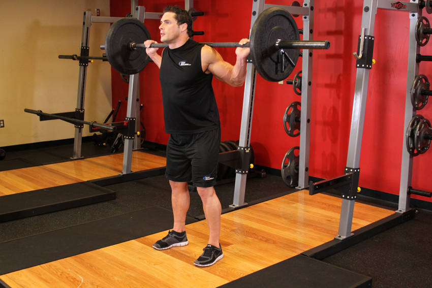 Demonstration of Barbell Full Squat exercise showing proper form and technique