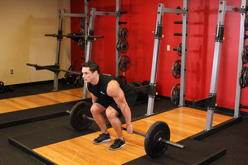 Demonstration of Barbell Hack Squat exercise showing proper form and technique