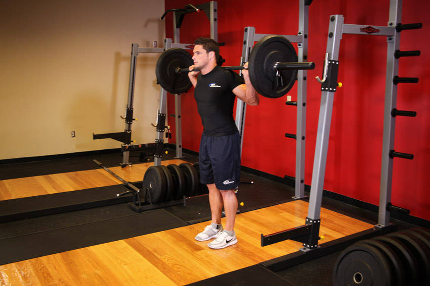 Demonstration of Barbell Lunge exercise showing proper form and technique