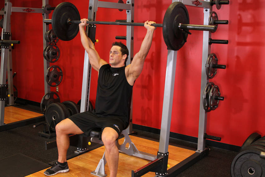 Demonstration of Barbell Shoulder Press exercise showing proper form and technique