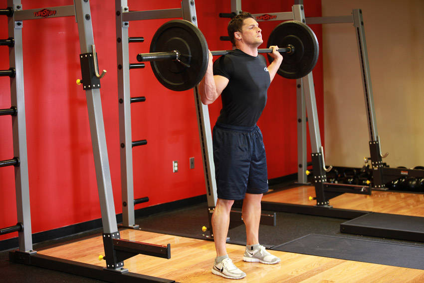 Demonstration of Barbell Squat exercise showing proper form and technique