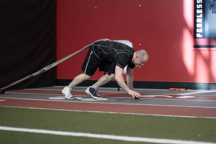 Demonstration of Bear Crawl Sled Drags exercise showing proper form and technique