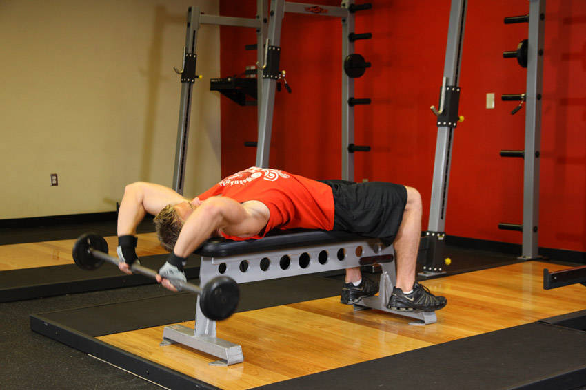 Demonstration of Bent-Arm Barbell Pullover exercise showing proper form and technique