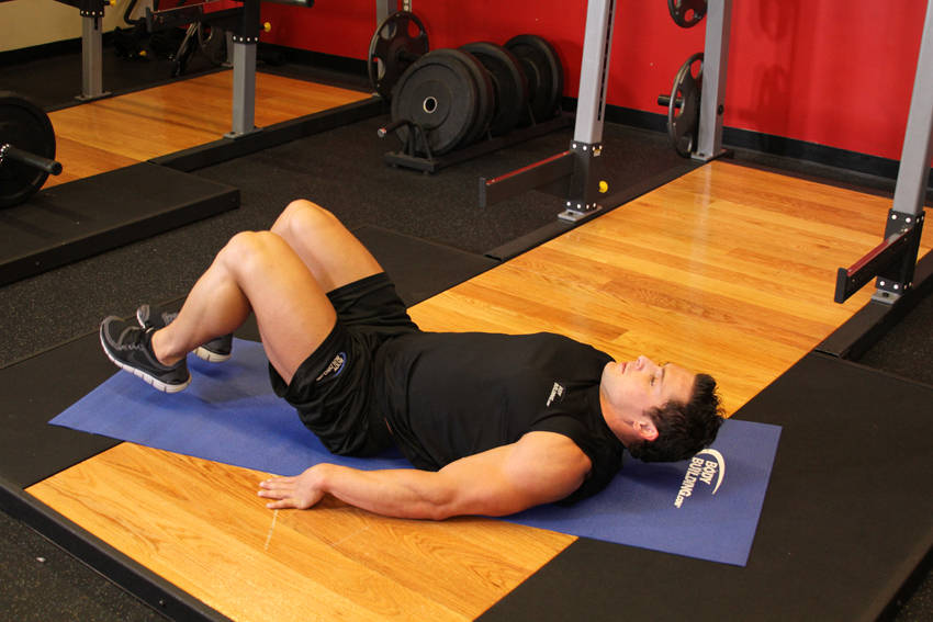 Demonstration of Bent-Knee Hip Raise exercise showing proper form and technique