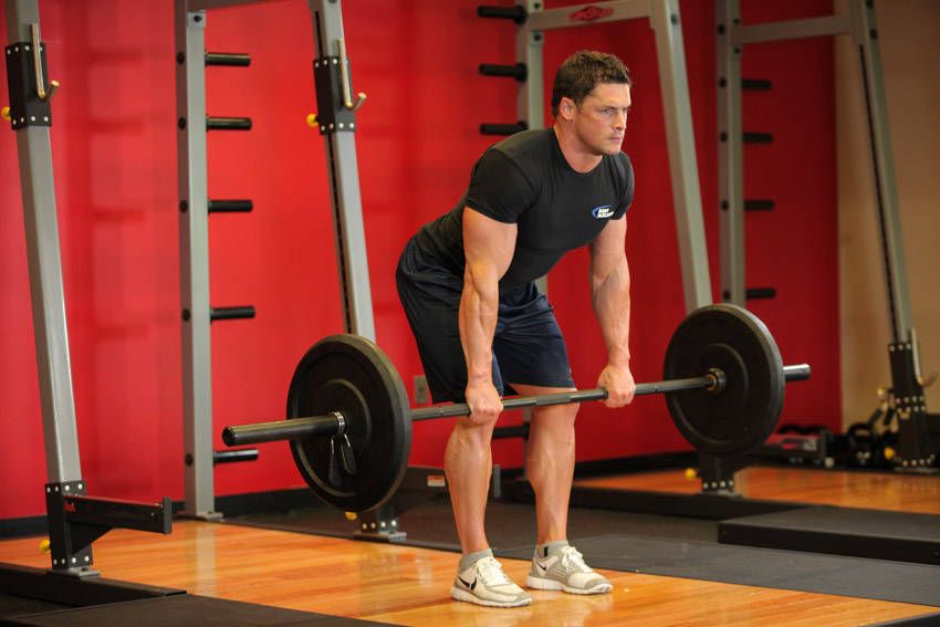 Demonstration of Bent Over Barbell Row exercise showing proper form and technique