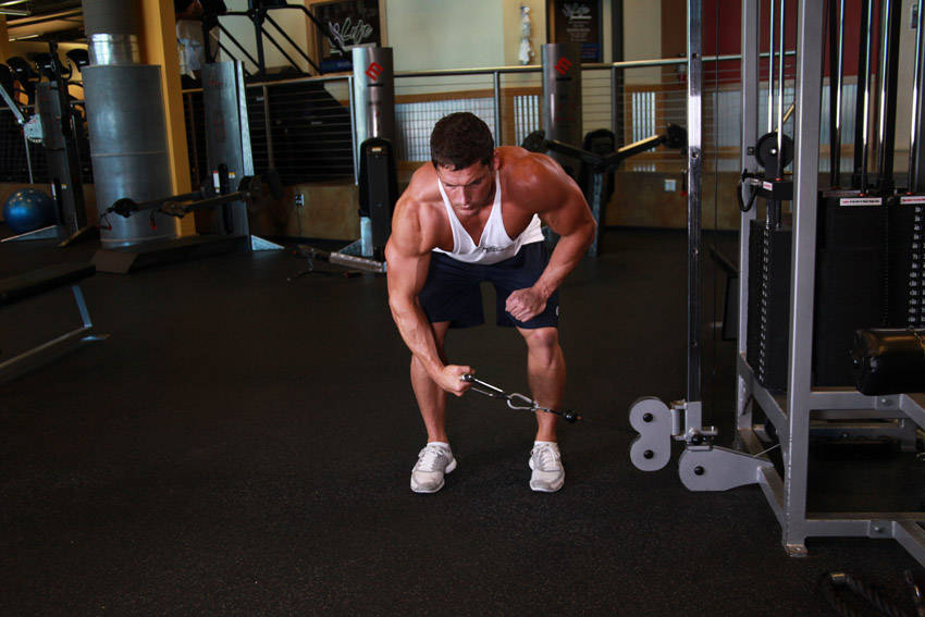 Demonstration of Bent Over Low-Pulley Side Lateral exercise showing proper form and technique