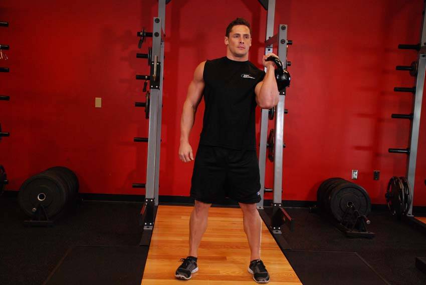 Demonstration of Bent Press exercise showing proper form and technique