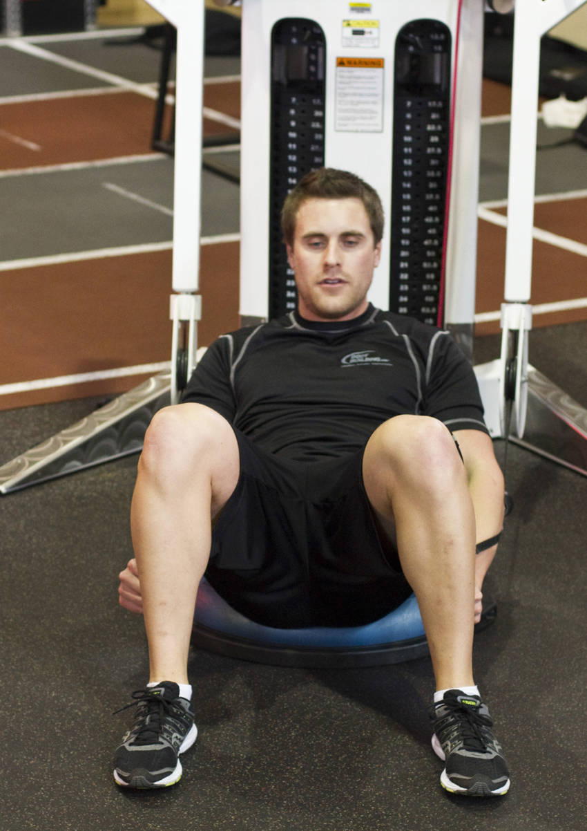 Demonstration of Bosu Ball Cable Crunch With Side Bends exercise showing proper form and technique