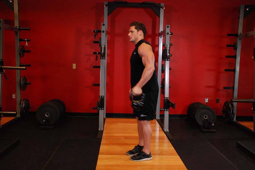 Demonstration of Bottoms-Up Clean From The Hang Position exercise showing proper form and technique