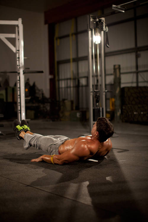 Demonstration of Bottoms Up exercise showing proper form and technique