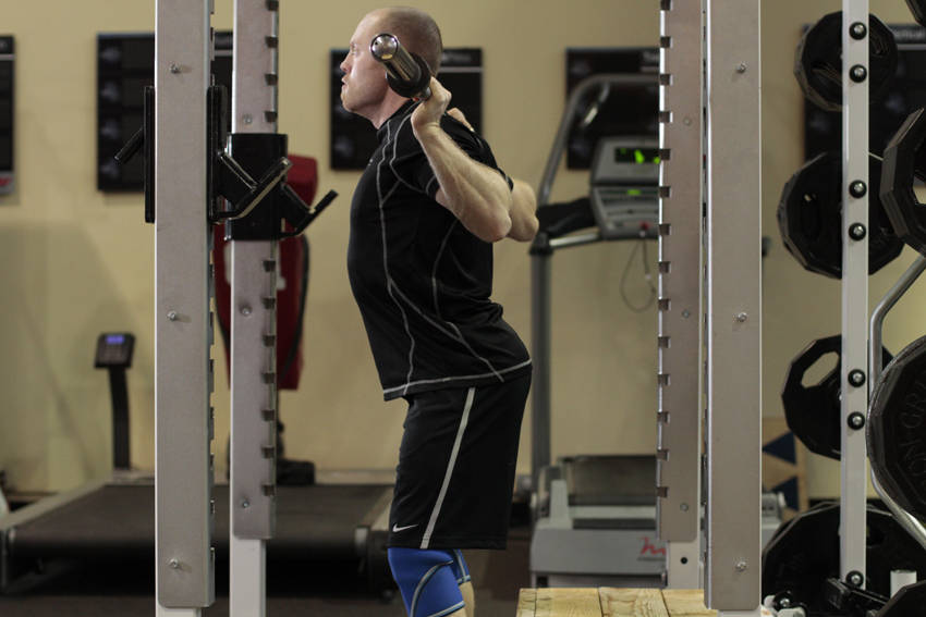 Demonstration of Box Squat exercise showing proper form and technique