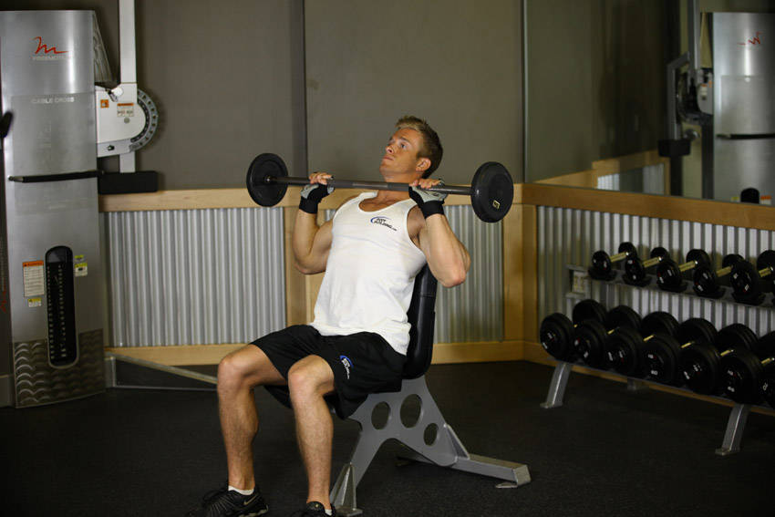Demonstration of Bradford/Rocky Presses exercise showing proper form and technique