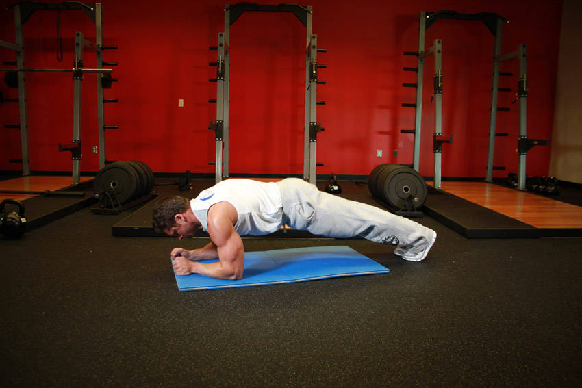 Demonstration of Butt-Ups exercise showing proper form and technique