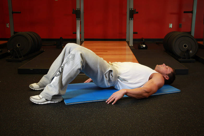 Demonstration of Butt Lift (Bridge) exercise showing proper form and technique