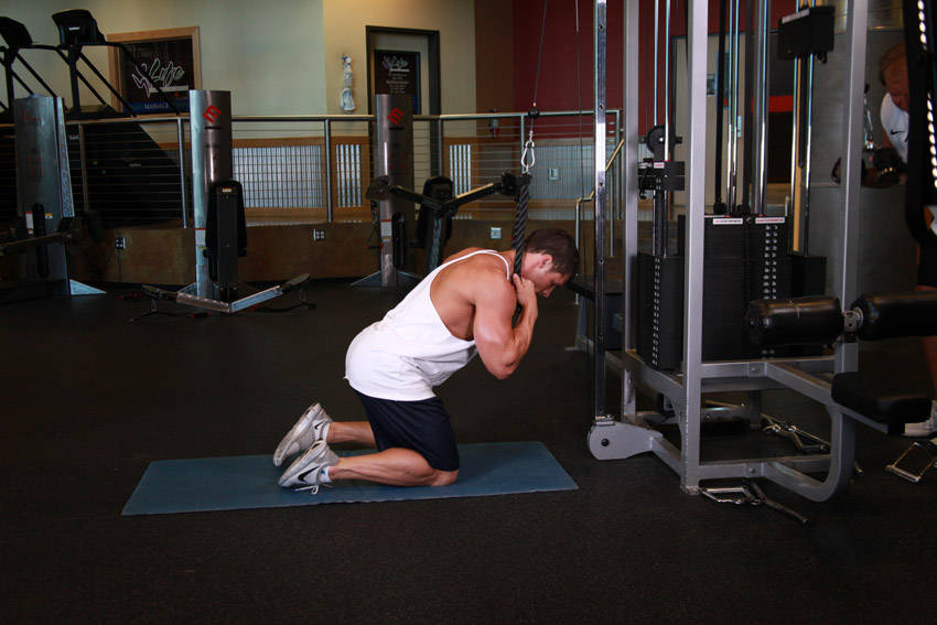 Demonstration of Cable Crunch exercise showing proper form and technique