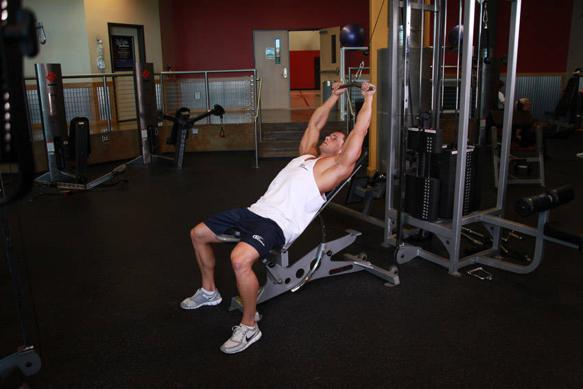 Demonstration of Cable Incline Pushdown exercise showing proper form and technique