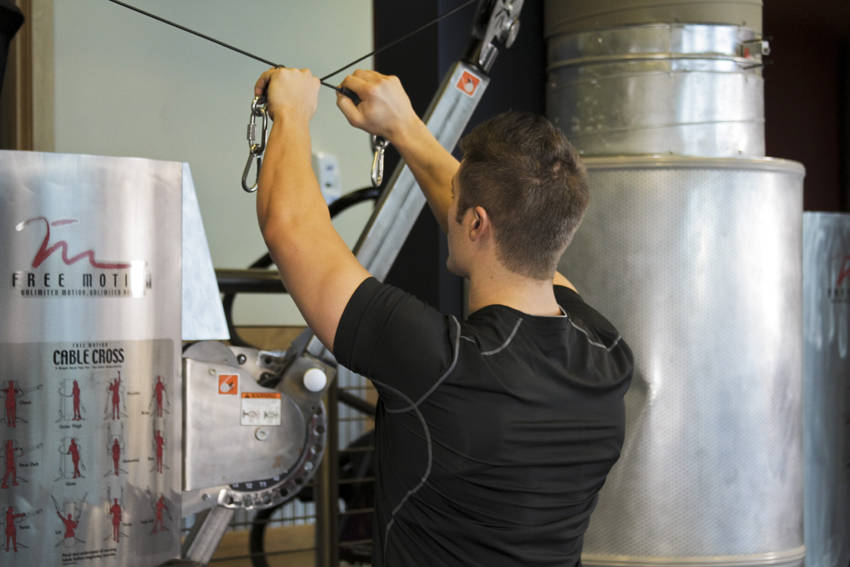 Demonstration of Cable Rear Delt Fly exercise showing proper form and technique