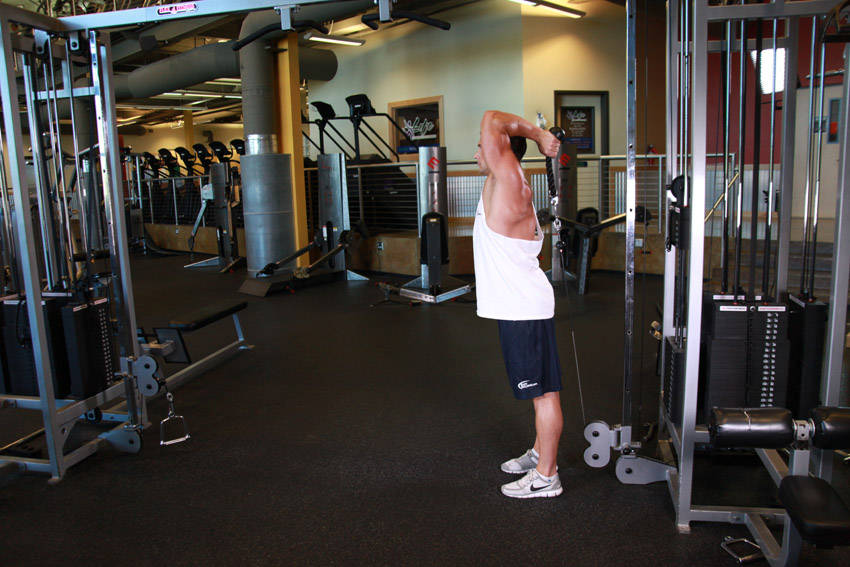Demonstration of Cable Rope Overhead Triceps Extension exercise showing proper form and technique