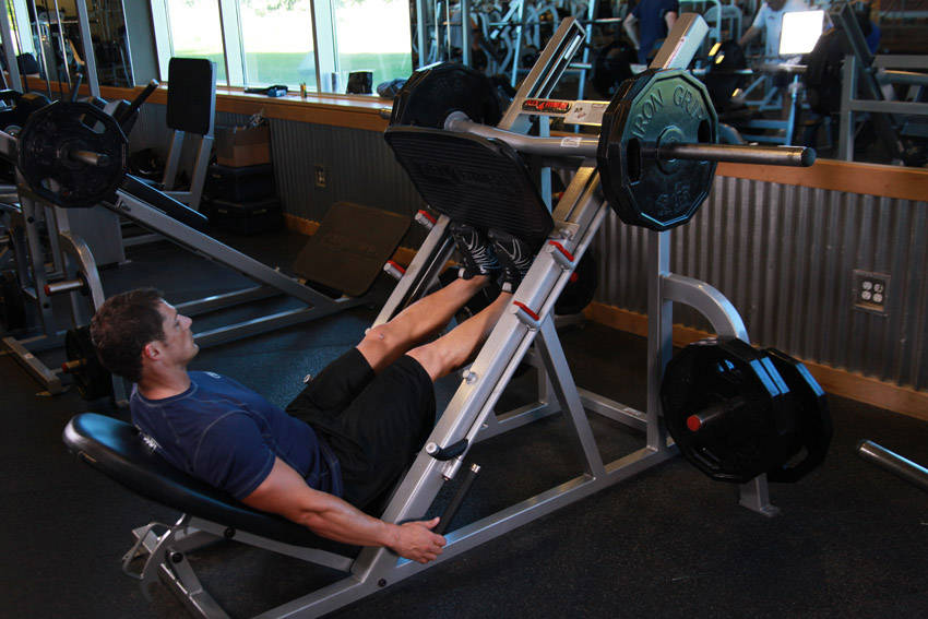 Demonstration of Calf Press On The Leg Press Machine exercise showing proper form and technique