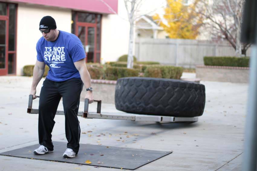 Demonstration of Car Deadlift exercise showing proper form and technique