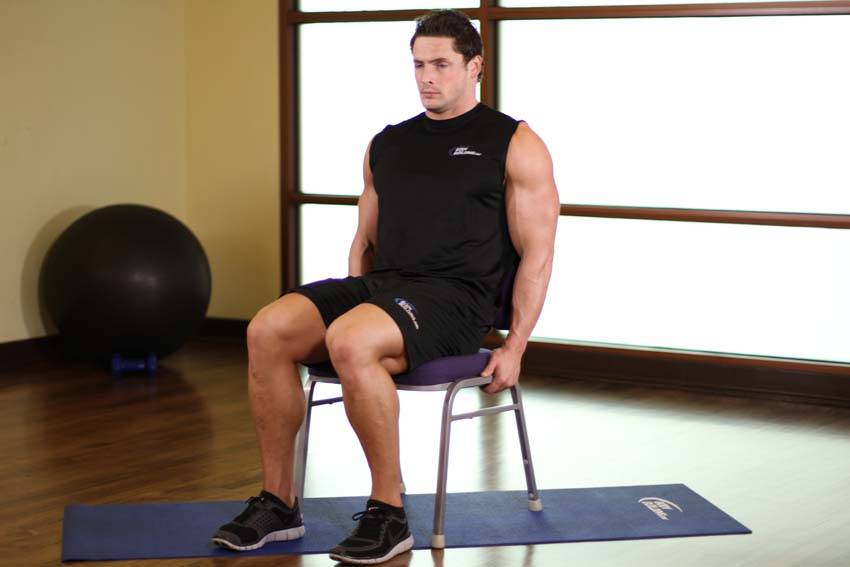 Demonstration of Chair Leg Extended Stretch exercise showing proper form and technique