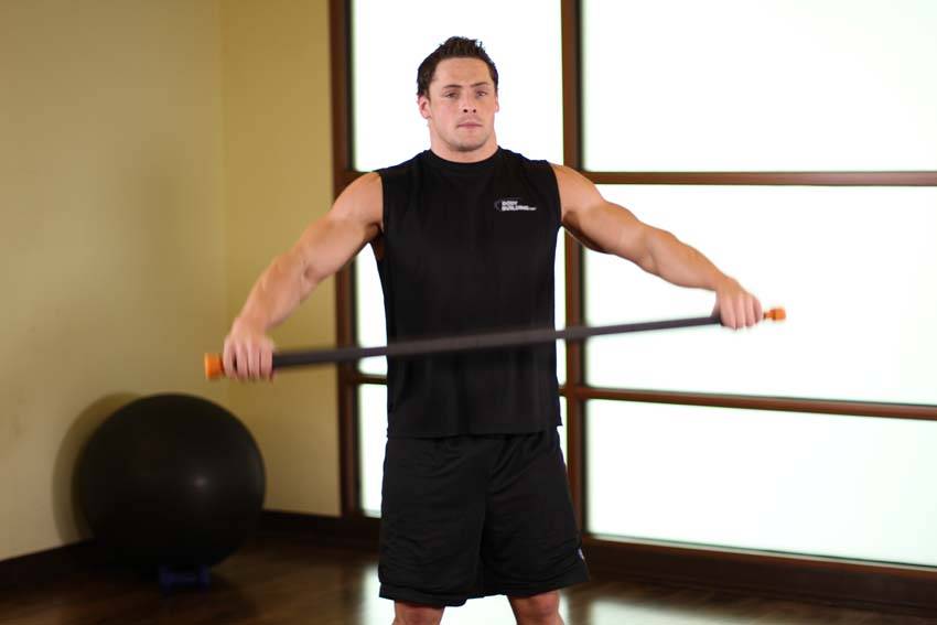 Demonstration of Chest And Front Of Shoulder Stretch exercise showing proper form and technique