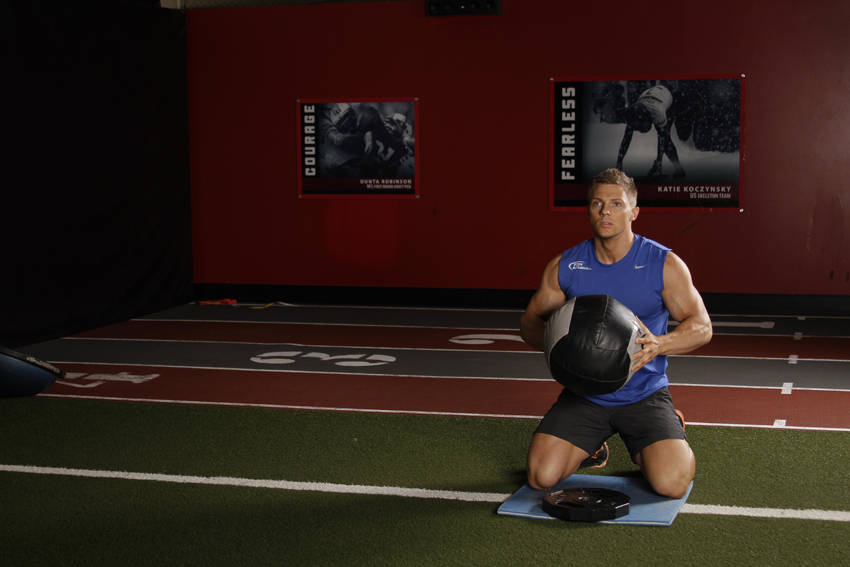 Demonstration of Chest Push (single response) exercise showing proper form and technique