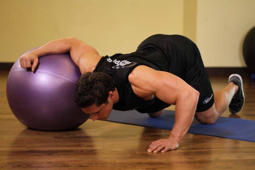 Demonstration of Chest Stretch on Stability Ball exercise showing proper form and technique