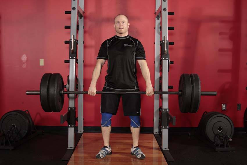 Demonstration of Clean Shrug exercise showing proper form and technique