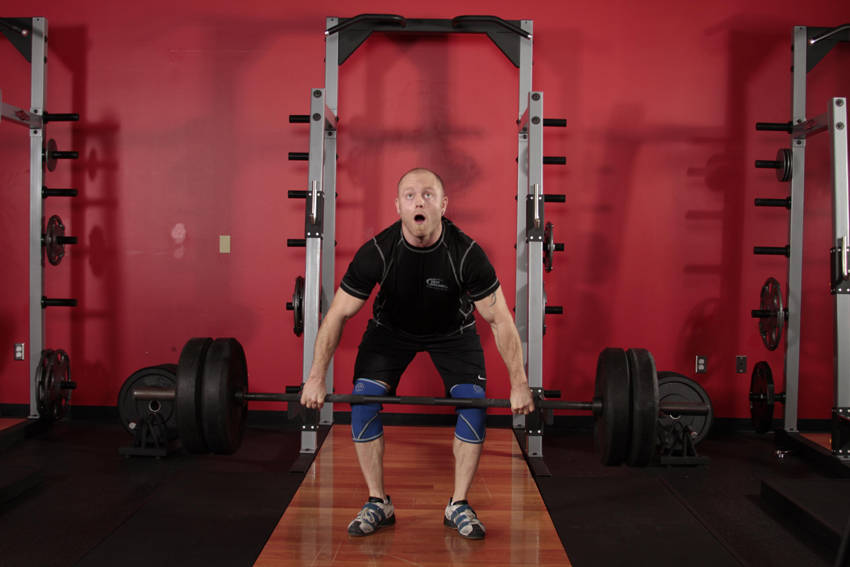 Demonstration of Clean and Jerk exercise showing proper form and technique