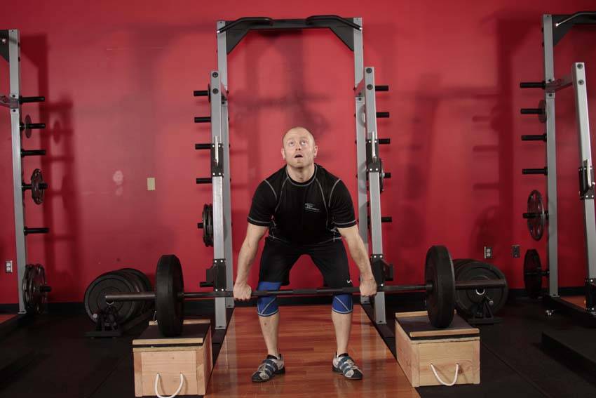 Demonstration of Clean from Blocks exercise showing proper form and technique
