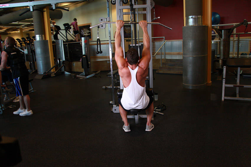 Demonstration of Close-Grip Front Lat Pulldown exercise showing proper form and technique