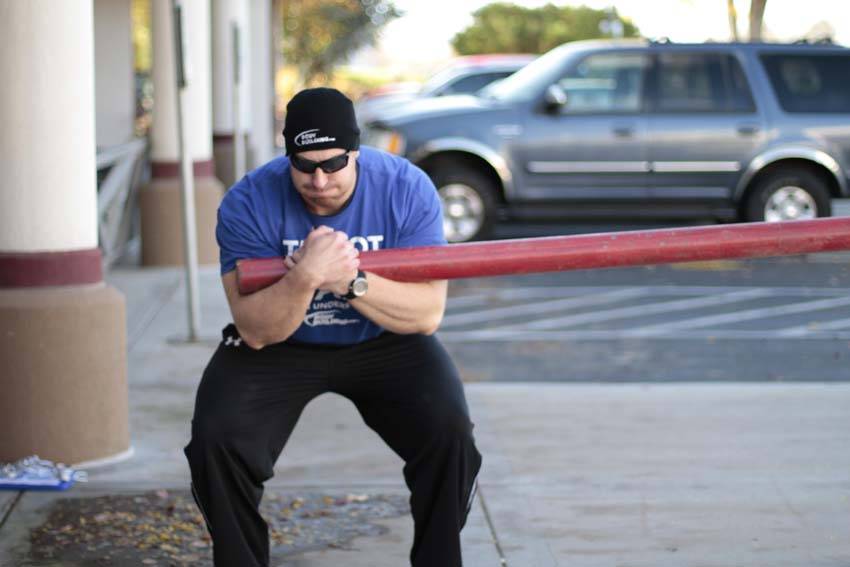 Demonstration of Conan's Wheel exercise showing proper form and technique