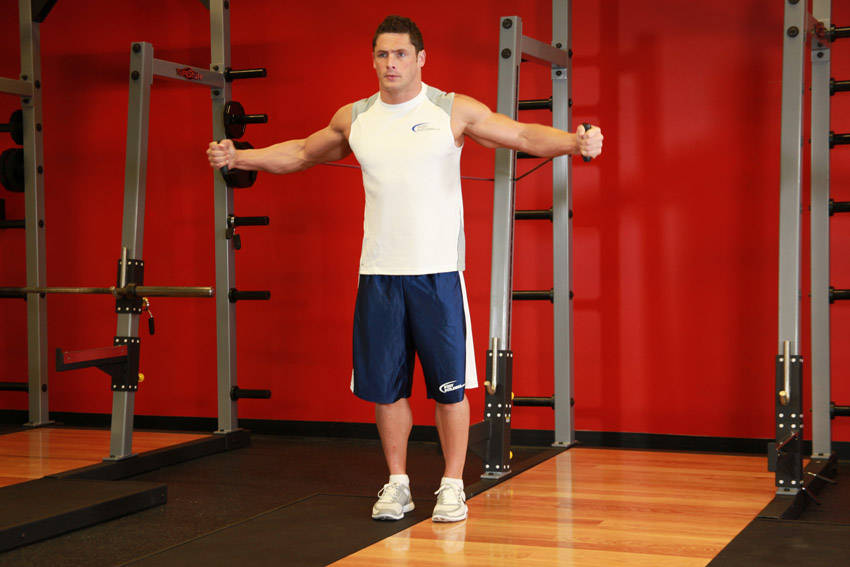 Demonstration of Cross Over - With Bands exercise showing proper form and technique