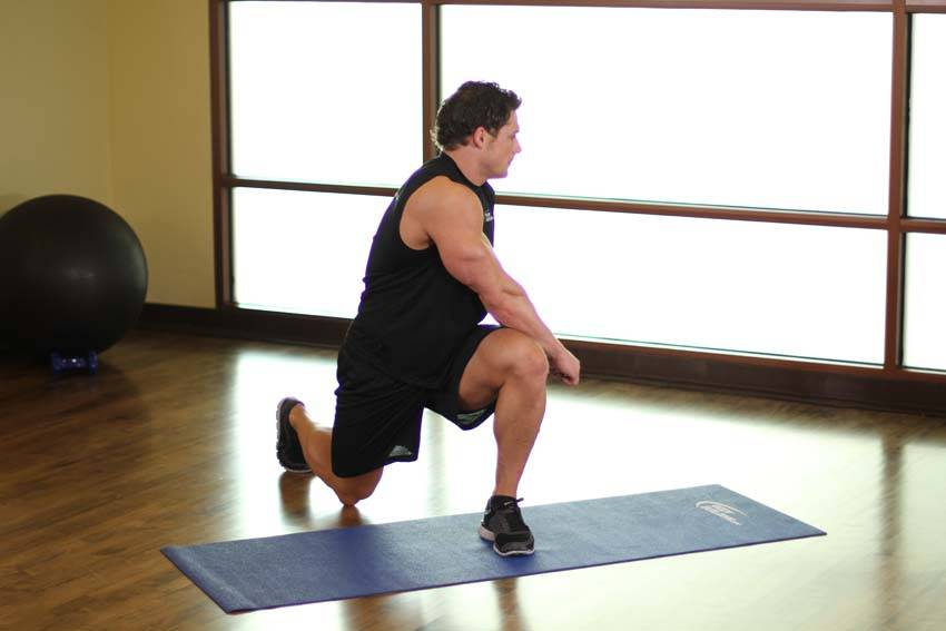 Demonstration of Crossover Reverse Lunge exercise showing proper form and technique