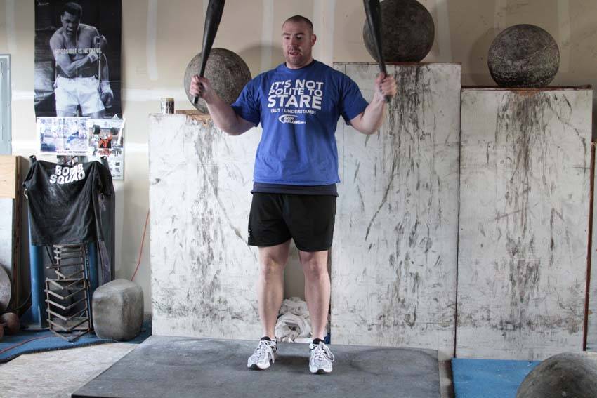 Demonstration of Crucifix exercise showing proper form and technique