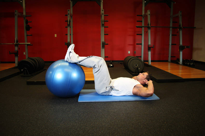 Demonstration of Crunch - Legs On Exercise Ball exercise showing proper form and technique