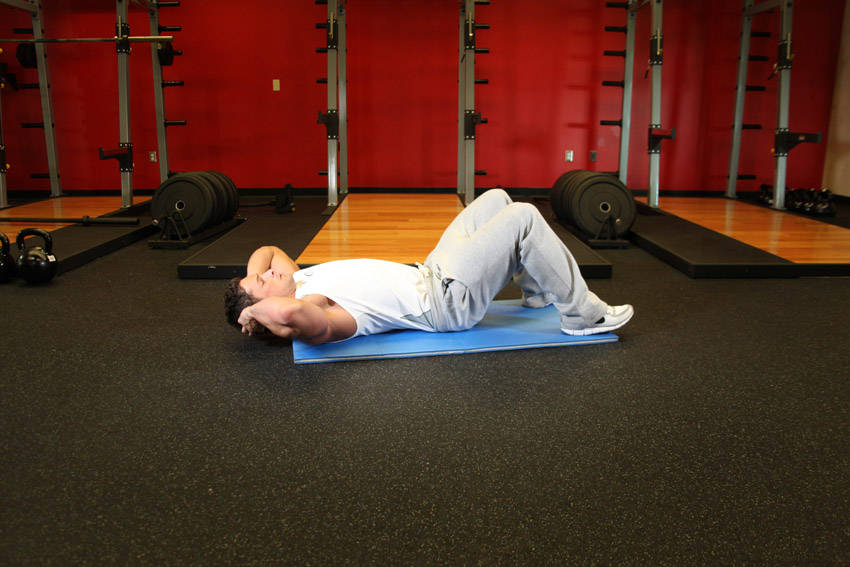 Demonstration of Crunches exercise showing proper form and technique