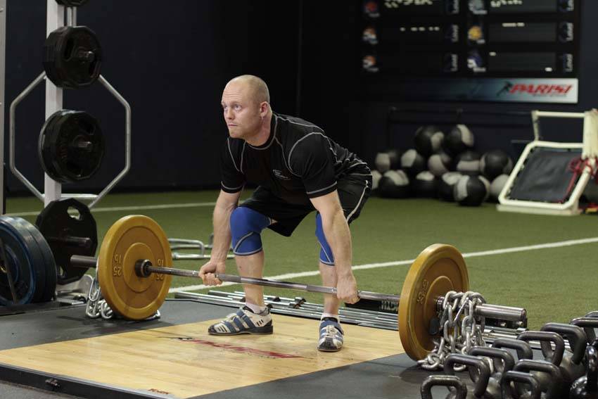 Demonstration of Deadlift with Chains exercise showing proper form and technique