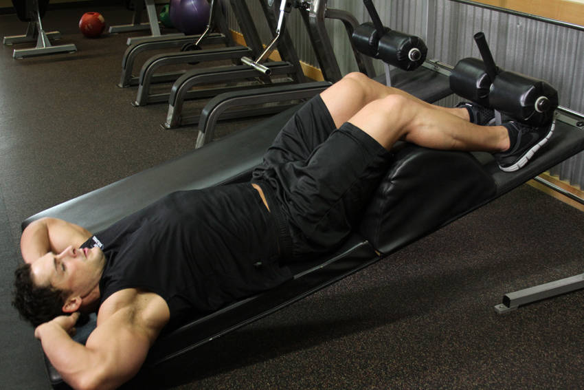 Demonstration of Decline Crunch exercise showing proper form and technique