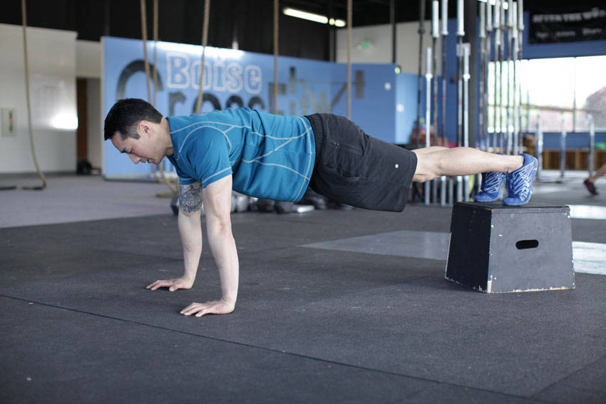 Demonstration of Decline Push-Up exercise showing proper form and technique