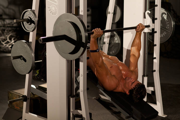 Demonstration of Decline Smith Press exercise showing proper form and technique